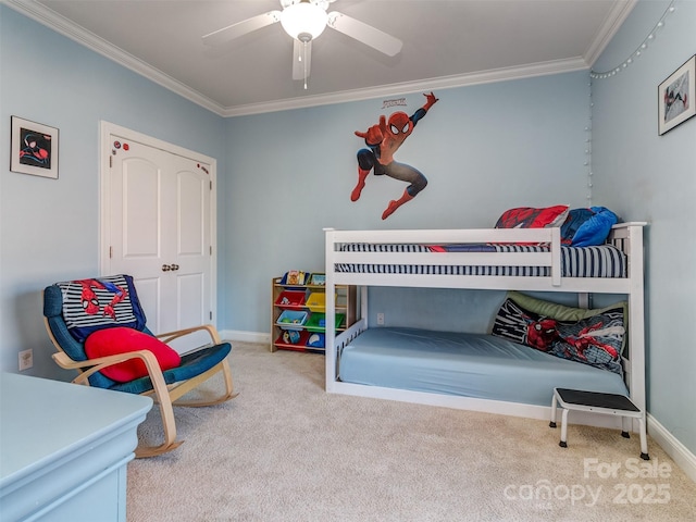 bedroom featuring ceiling fan, crown molding, and carpet flooring