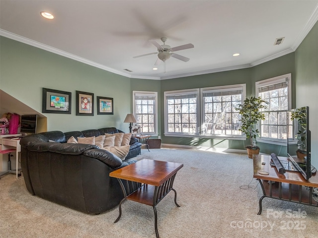 living room featuring a wealth of natural light, ceiling fan, ornamental molding, and light carpet