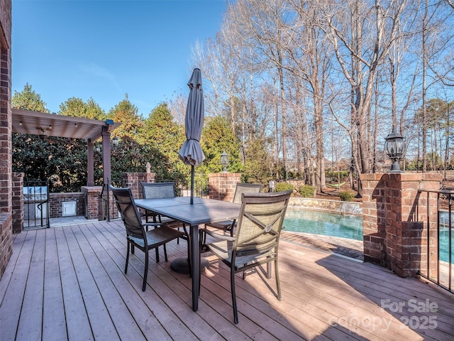 wooden deck featuring a pergola and area for grilling