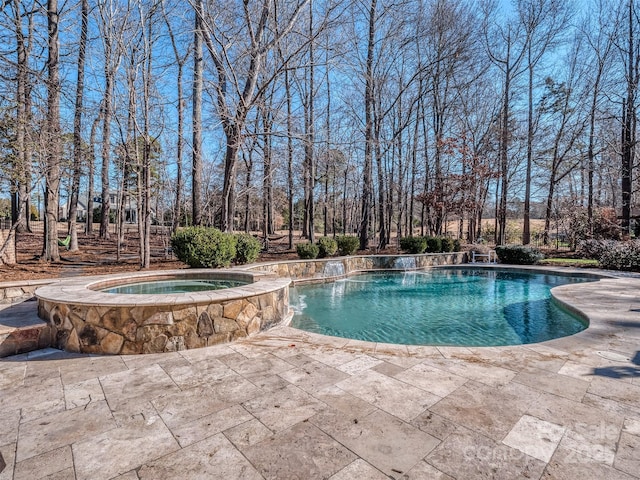 view of swimming pool featuring a patio area and an in ground hot tub