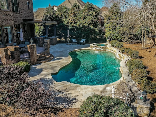 view of swimming pool with an in ground hot tub and a patio area