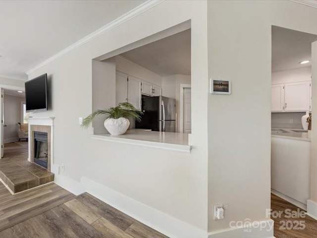 interior space featuring crown molding and hardwood / wood-style floors