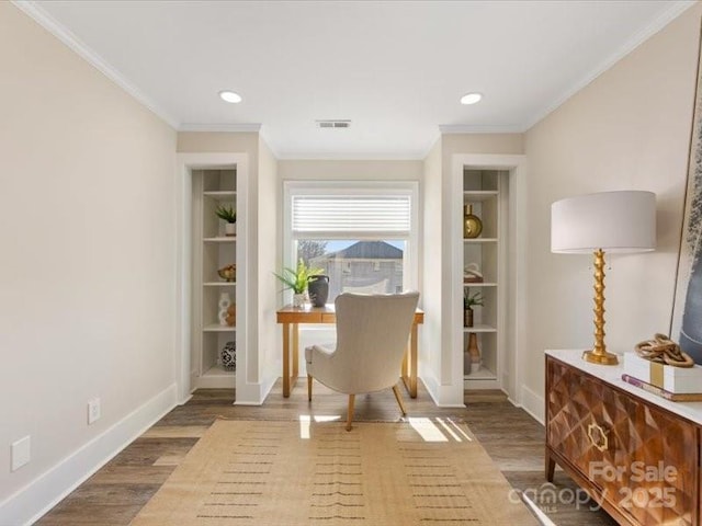 office space with built in shelves, ornamental molding, and wood-type flooring