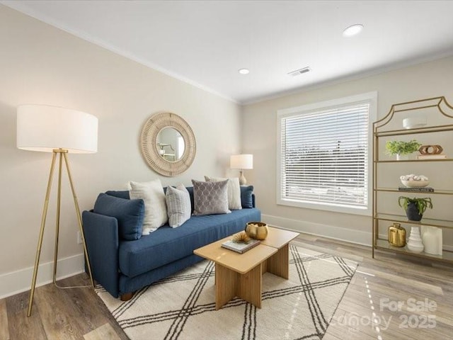 living room with ornamental molding and hardwood / wood-style floors