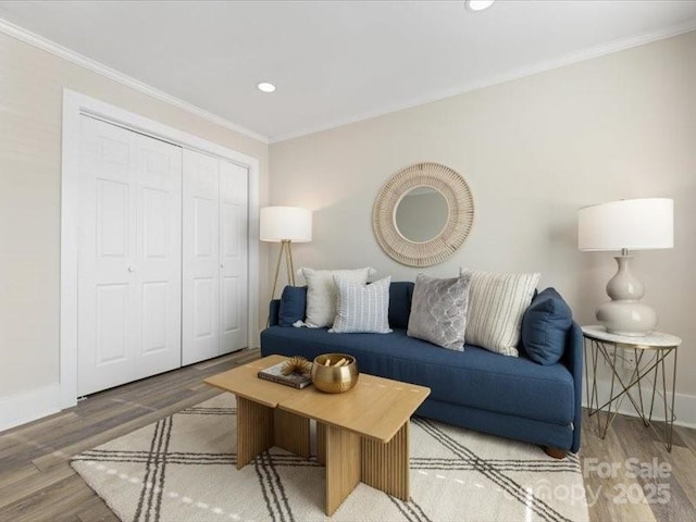 living room featuring crown molding and hardwood / wood-style flooring