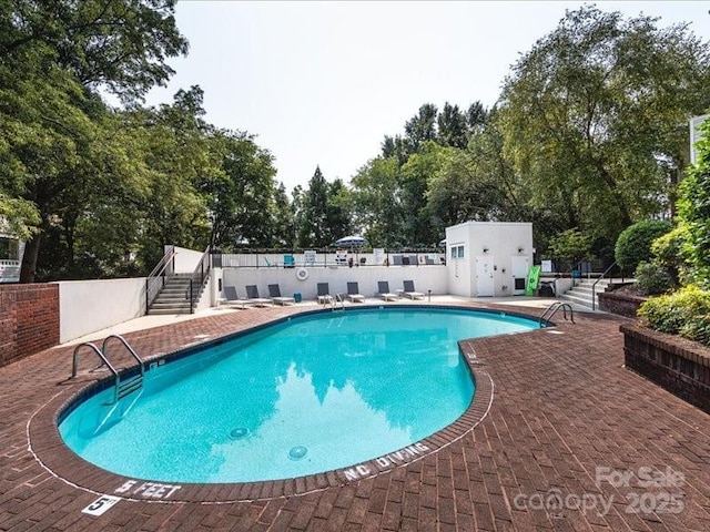 view of swimming pool with a patio