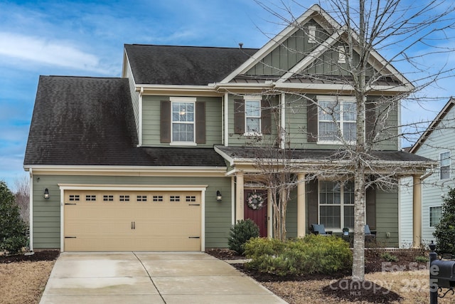 craftsman-style house featuring board and batten siding, roof with shingles, and driveway