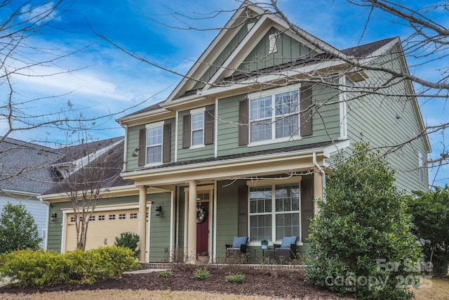 view of front facade featuring covered porch and an attached garage