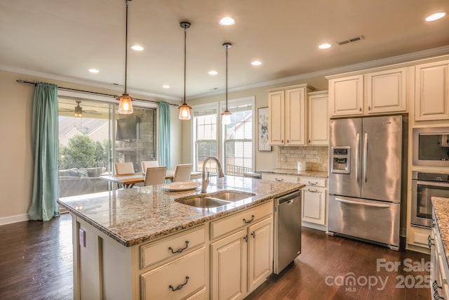 kitchen featuring stainless steel appliances, dark wood-type flooring, a sink, visible vents, and crown molding