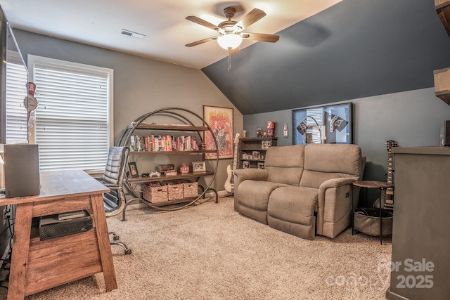 interior space featuring a ceiling fan, visible vents, vaulted ceiling, and carpet flooring