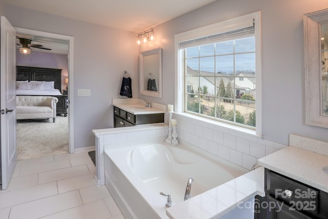 ensuite bathroom featuring a ceiling fan, ensuite bath, a garden tub, tile patterned flooring, and vanity