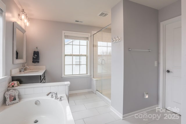 bathroom with visible vents, a shower stall, baseboards, and a bath