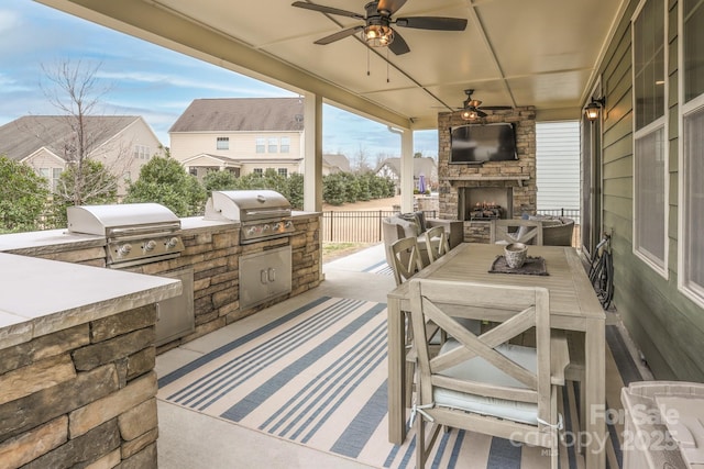 view of patio / terrace featuring ceiling fan, exterior kitchen, area for grilling, and fence