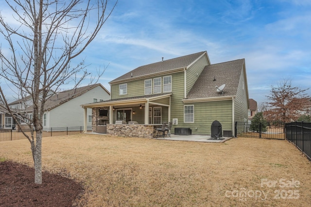 rear view of house featuring ceiling fan, a patio, a fenced backyard, a yard, and roof with shingles