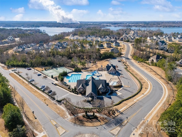 drone / aerial view with a water view and a residential view