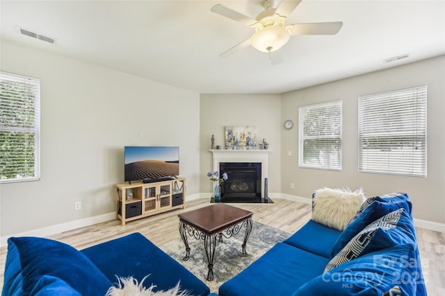 living room featuring light hardwood / wood-style flooring and ceiling fan