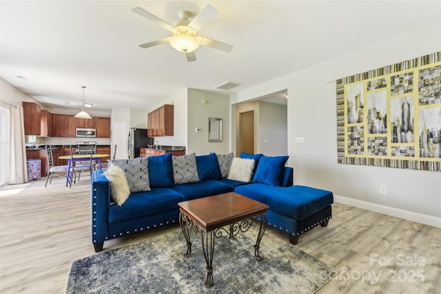 living room with light wood-type flooring and ceiling fan