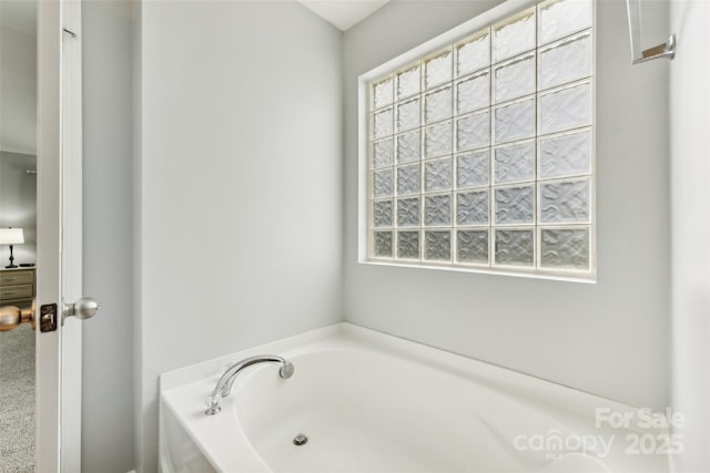 bathroom featuring a tub to relax in