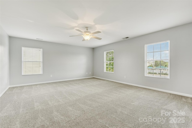 carpeted empty room featuring ceiling fan