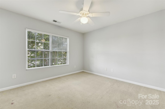 unfurnished room with ceiling fan and carpet floors