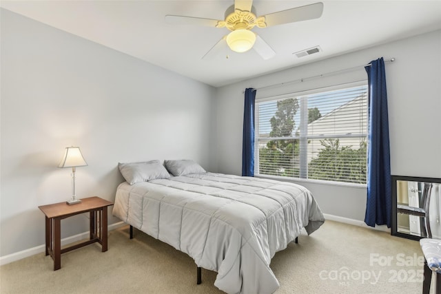 bedroom with ceiling fan and light carpet