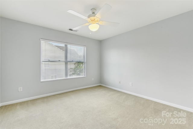 unfurnished room featuring ceiling fan and light carpet