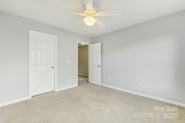 unfurnished bedroom featuring light carpet and ceiling fan