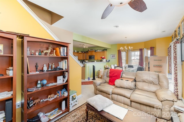 carpeted living room featuring ceiling fan with notable chandelier