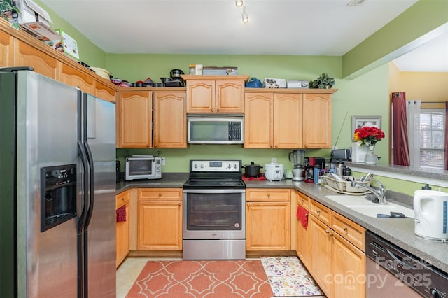 kitchen featuring sink, stainless steel appliances, and light tile patterned floors