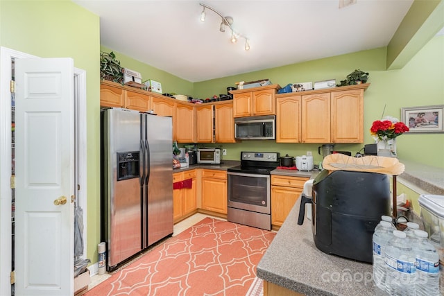 kitchen featuring appliances with stainless steel finishes and light tile patterned floors