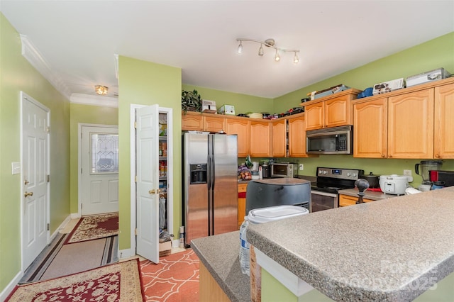 kitchen with a kitchen island, appliances with stainless steel finishes, ornamental molding, and light tile patterned floors