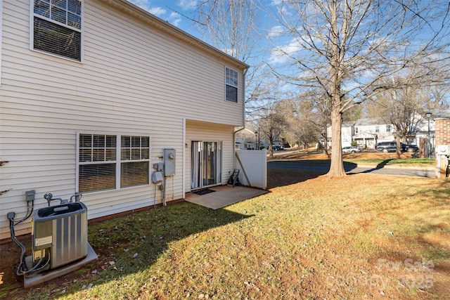 exterior space featuring a yard and central AC