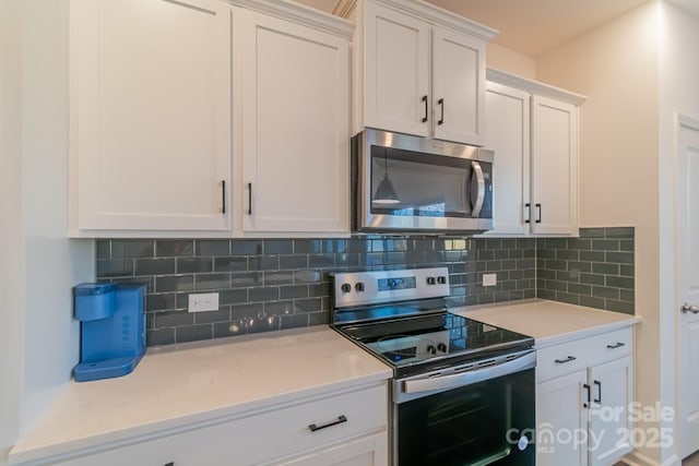 kitchen with white cabinets, tasteful backsplash, and stainless steel appliances