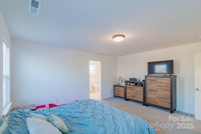 bedroom featuring baseboards, multiple windows, visible vents, and light colored carpet