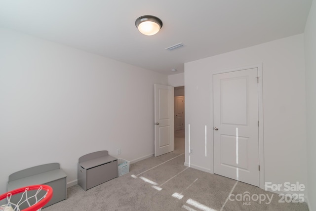 bedroom featuring carpet floors, visible vents, and baseboards