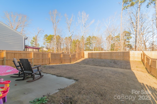 view of yard featuring a patio area and a fenced backyard