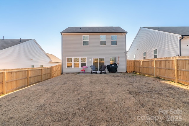 back of property with a fenced backyard