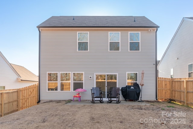 back of house featuring a fenced backyard