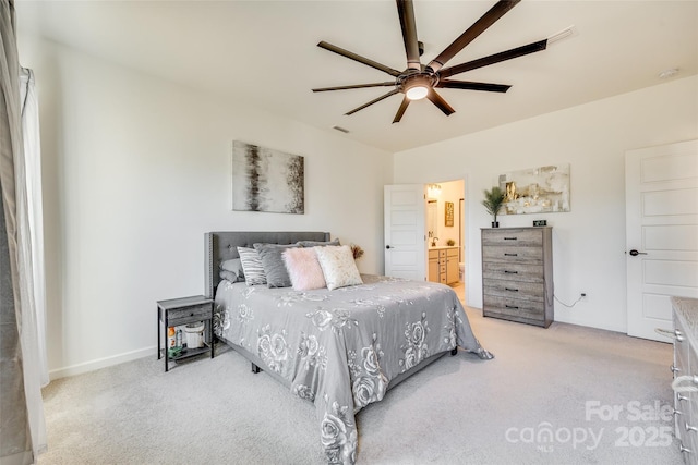 bedroom featuring ensuite bathroom, ceiling fan, and light colored carpet