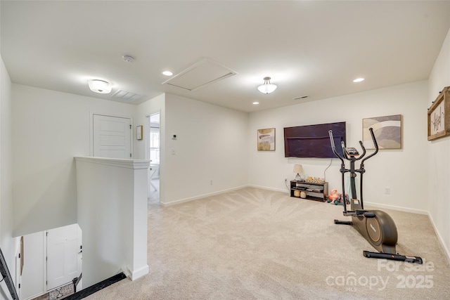 exercise room featuring light carpet