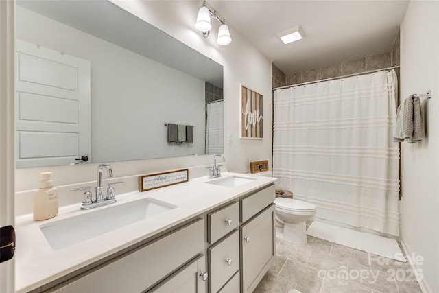 bathroom with tile patterned floors, vanity, and toilet