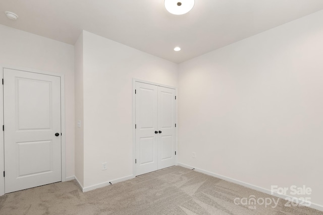 empty room featuring light colored carpet