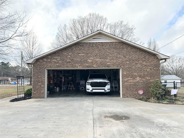 view of side of property featuring a garage and an outbuilding