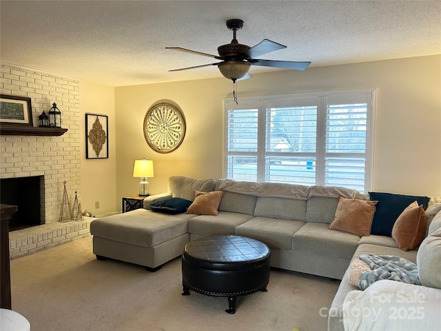 carpeted living room featuring a fireplace, a textured ceiling, and ceiling fan