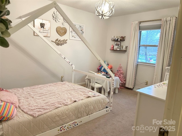 carpeted bedroom featuring a chandelier