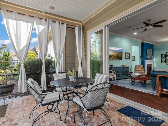 sunroom featuring ceiling fan