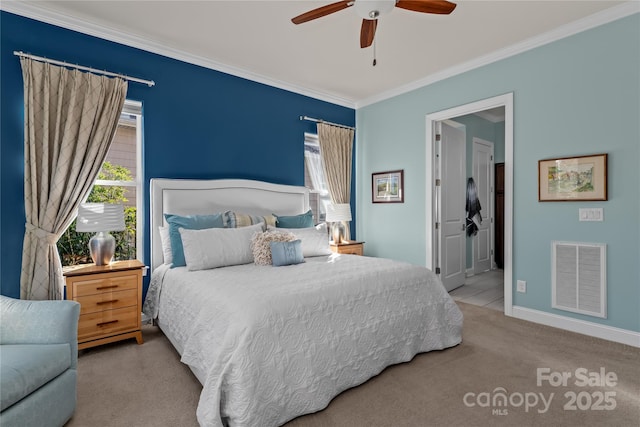 carpeted bedroom featuring ensuite bathroom, ceiling fan, and ornamental molding