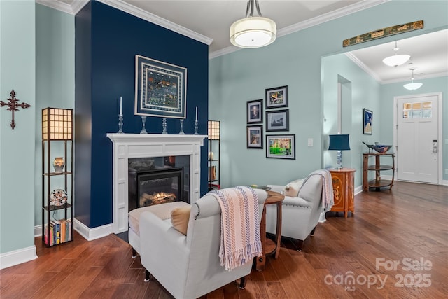 living room featuring dark hardwood / wood-style flooring, ornamental molding, and a high end fireplace