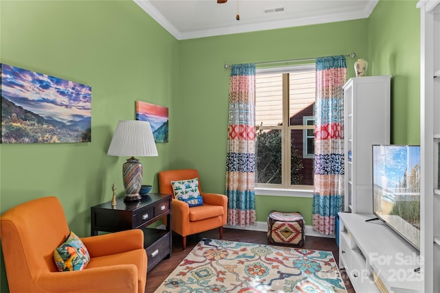 living area featuring ceiling fan, dark hardwood / wood-style flooring, and ornamental molding