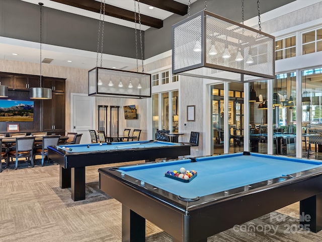 recreation room with pool table, light colored carpet, beamed ceiling, and a high ceiling